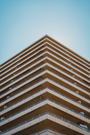 Geometric angle of a modern residential building facade against a clear blue sky. Sant Antoni beach, Cullera, Spainの写真素材