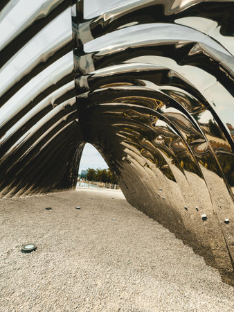 Interior view of a modern metal pavilion with reflective surfaces and curved lines, capturing innovative architecture and contemporary design.の写真素材