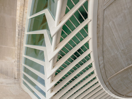 Innovative building design featuring a curved facade and intricate window patterns, showcasing...