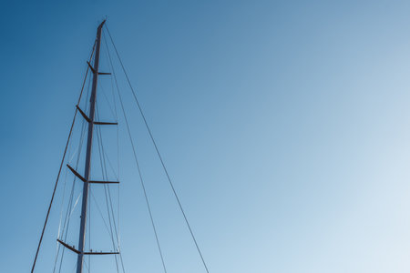 A captivating and striking silhouette of a tall tower lasting against a clear blue sky aboveの写真素材