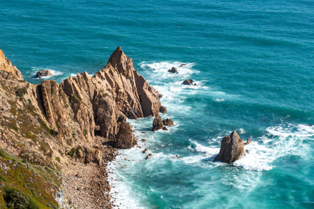 Stunning jagged cliffs and turquoise waves crash along the scenic Lisbon coastline, perfect for travel inspiration, nature backgrounds, or Portugal tourism promotion.の写真素材