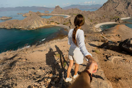 A woman walking on the top of the mountainの写真素材