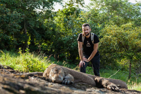 A man standing next to Komodo dragonのeditorial素材