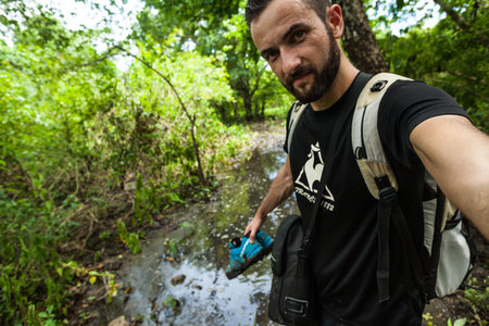 A man taking a selfie in the monsoon forest