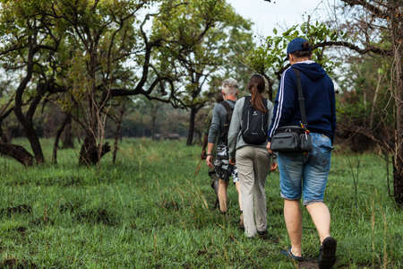 ZIWA RHINO SANCTUARY, UGANDA - MARCH 16, 2018: Unidentified people walk through the jungle on March 16, 2018 in Ziwa Rhino Sanctuary, Ugandaのeditorial素材