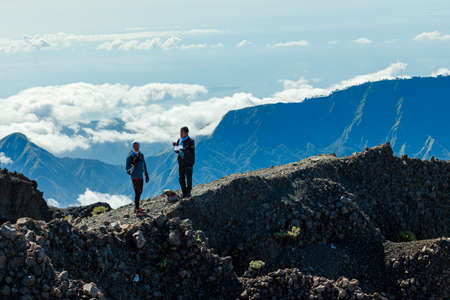 MOUNT RINJANI NATIONAL PARK - INDONESIA - JULY 23, 2016:Two men stand on the rocky surface of Mount Rinjani on July 23, 2016 in Lombok, Indonesiaのeditorial素材