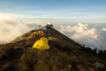 MOUNT RINJANI NATIONAL PARK, INDONESIA - JULY 22, 2016: People camp on top of the mountains on July 22, 2016 in Mount Rinjani National Park, Indonesiaのeditorial素材