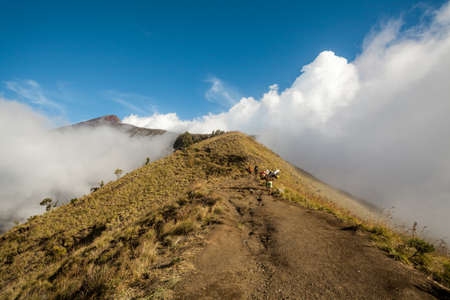 MOUNT RINJANI NATIONAL PARK - INDONESIA - JULY 22, 2016: People walk on the mountain towards the peak. Trek to Mount Rinjani on July 22, 2016 in Lombok, Indonesiaのeditorial素材