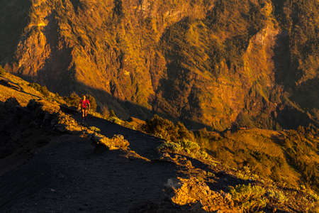 MOUNT RINJANI NATIONAL PARK, INDONESIA - JULY 23, 2016: An unidentified man walks on the edge of Mount Rinjani on July 23, 2016 in Mount Rinjani National Park, Indonesiaのeditorial素材