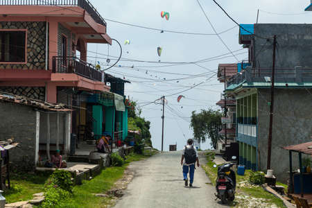 POKHARA, NEPAL - MAY 31, 2016: An unidentified man walks along the town street on May 31, 2016 in Pokhara, Nepalのeditorial素材