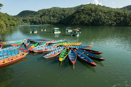 Colourful boats docked on Phewa lake, Pokhara, Nepal.の写真素材