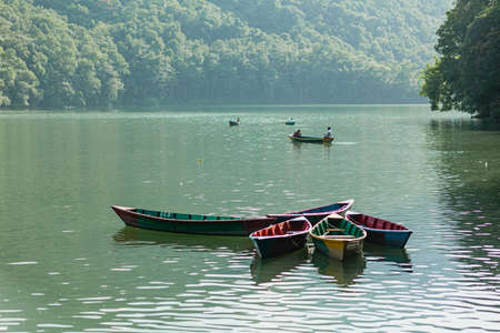 POKHARA - NEPAL, MAY 30, 2016: Floating boats with tourists on Phewa lakeのeditorial素材