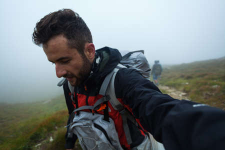 A man takes a selfie while walking. Ukrainian Carpathiansの写真素材