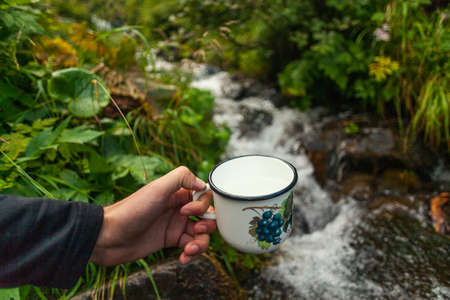 A hand with an iron cup. Carpathian mountains, Ukraineの写真素材