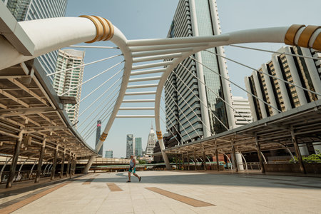 BANGKOK , THAILAND, APRIL 2, 2017: A man walks towards the link pedestrian bridgeのeditorial素材
