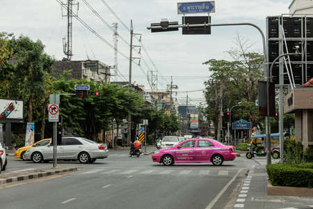 BANGKOK, THAILAND - MAY 3, 2014: A pink taxi moves along the roadのeditorial素材