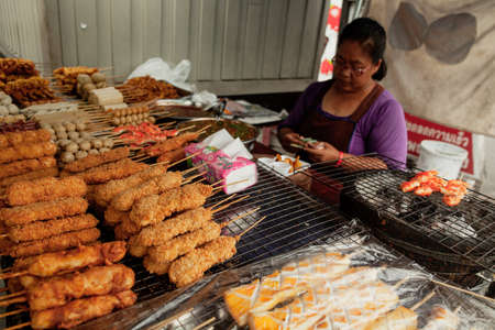 BANGKOK, THAILAND - MAY 3, 2014: Thai lady at the stall with street foodのeditorial素材