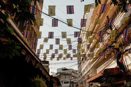 Tiny flags attached to wires above the street, Bangkok, Thailand
