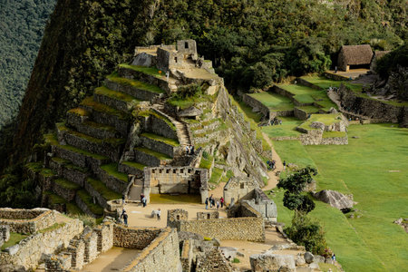 MACHU PICCHU, PERU - MARCH 9, 2019: Visitors walk around the Machu Picchu ruinsのeditorial素材