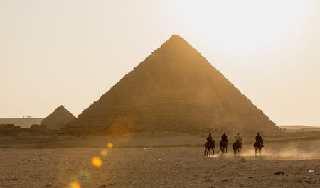 CAIRO, EGYPT- NOVEMBER 17, 2018:Four horse riders move towards the pyramid of Gizaのeditorial素材