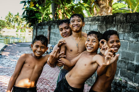 BALI, INDONESIA - MARCH 2, 2014: Happy teen boys with wide smiles on their facesのeditorial素材