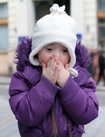 Little scared girl hiding faceの写真素材