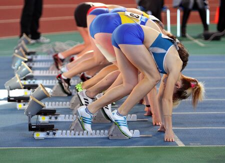 Unidentified girls on the start of the 60 meters dash during the Ukainian Track and Field Championships on February 17, 2012 in Sumy, Ukraine. のeditorial素材