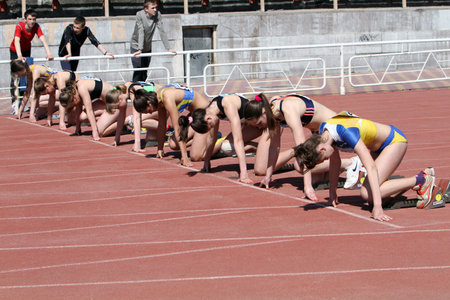 YALTA, UKRAINE - APRIL 25  Unidentified girls age 16-17 on the start of the 100 meters race on...