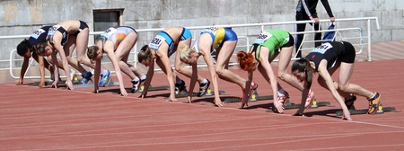 YALTA, UKRAINE - APRIL 25  Unidentified girls age 16-17 on the start of the 100 meters race on Ukrainian Junior Track and Field Championships on April 25, 2012 in Yalta, Ukraine  のeditorial素材