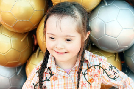 The little girl on the background of soccer balls.の写真素材
