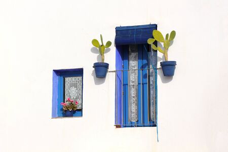 Blue windows on the white wall in Peniscola, Spainの写真素材