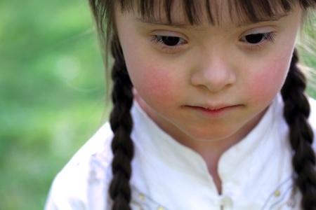 Portrait of beautiful young girl on the green background.の写真素材