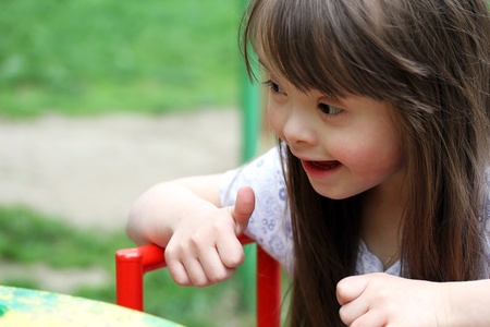 Portrait of beautiful young girl on the playgroundの写真素材