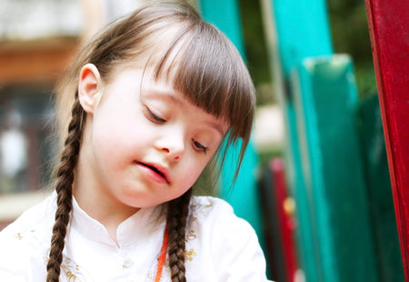 Portrait of beautiful young girl on the playground.の写真素材