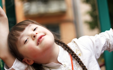 Portrait of happy little girl on the playground.の写真素材