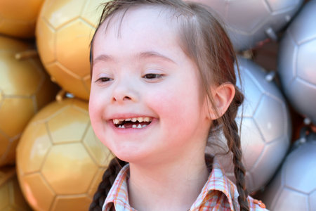 The little girl on the background of soccer balls.