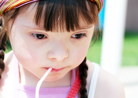 Portrait of little girl drinking juiceの写真素材