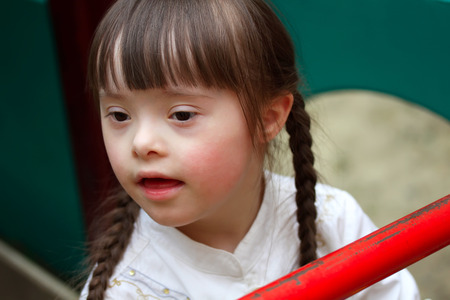 Portrait of beautiful young girl on the playground.の写真素材