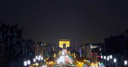 Champs-Elysees Avenue with the Arc de Triomphe in Paris France at night.のeditorial素材