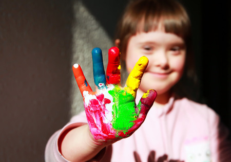 Cute little girl with painted handsの写真素材