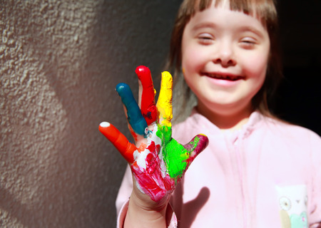 Cute little girl with painted handの写真素材