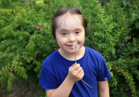 Little girl blowing dandelion