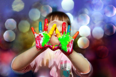 Cute little kid with painted hands.の写真素材