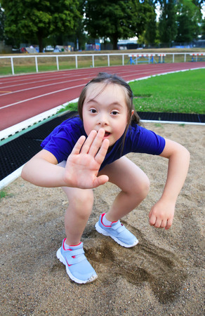 Little girl have fun on the stadiumの写真素材