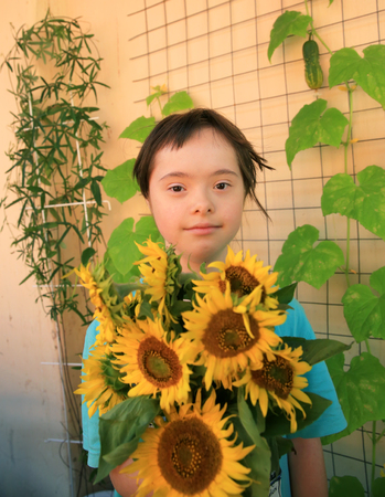 Little girl with sunflowersの写真素材