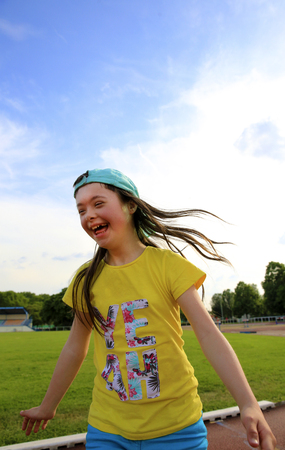 Little girl have fun on the stadiumの写真素材