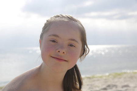 Portrait of little girl smiling on the background of the seaの写真素材