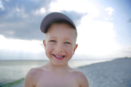 Cute smiling little boy on the sea beach