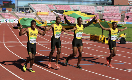 TAMPERE, FINLAND, July 14: Jamaican 4x100 relay team running with flags after winning silver on the IAAF World U20 Championship in Tampere, Finland 14 July, 2018のeditorial素材