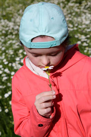 Young girl on the background of flowers fieldの写真素材